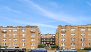 Philadelphia apartment for rent - A large brick building with a parking lot in front.