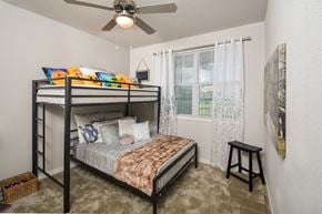 Austin apartment for rent - A bedroom with a bunk bed and a small table.