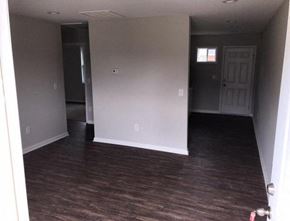 Rocky Mount apartment for rent - an empty living room with white walls and wood floors