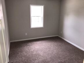 Rocky Mount apartment for rent - an empty room with a window and gray carpet