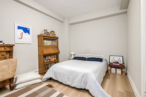 Chicago apartment for rent - a bedroom with a large bed and a bookshelf