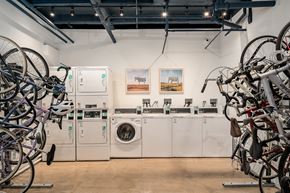 Chicago apartment for rent - a laundry room with washing machines and bicycles hanging on the wall