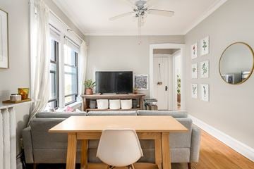 Chicago apartment for rent - a living room with a couch and a table and a tv