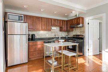 Chicago apartment for rent - A kitchen with a stove top oven and a refrigerator.