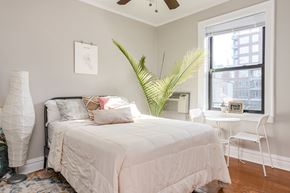 Chicago apartment for rent - A bedroom with a large bed and a window.