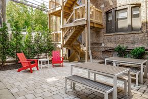 Chicago apartment for rent - a patio with tables and chairs and a staircase