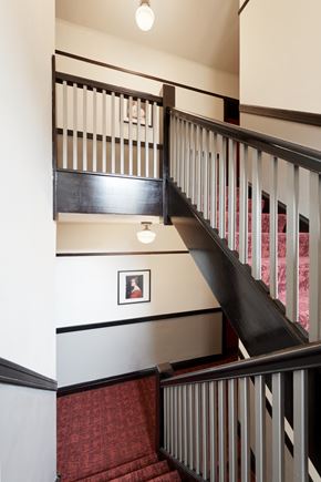 Chicago apartment for rent - a stairwell with black and white stairs and a picture on the wall