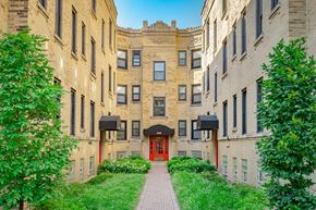 Chicago apartment for rent - a brick building with a red door and a walkway