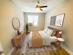 Chicago apartment for rent - a bedroom with a bed and a ceiling fan