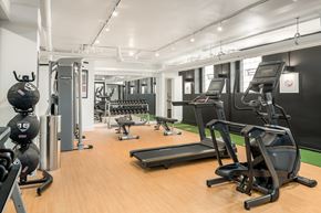 Chicago apartment for rent - A gym with a variety of equipment including treadmills, weights, and exercise machines.