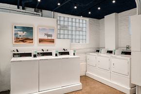 Chicago apartment for rent - a white kitchen with white appliances and pictures on the wall