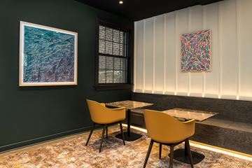 Chicago apartment for rent - a dining room with two tables and chairs and two paintings on the wall