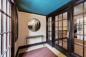Chicago apartment for rent - a hallway with glass doors and a mirror