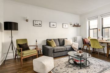 Chicago apartment for rent - a living room with a gray couch and a glass coffee table