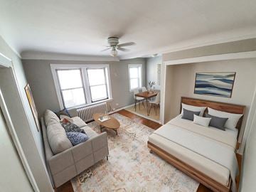 Chicago apartment for rent - A bedroom with a bed, couch, and rug.