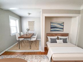 Chicago apartment for rent - A bedroom with a bed, a table and chairs, and a painting on the wall.