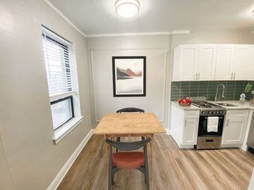 Chicago apartment for rent - A kitchen with a table and chairs in front of a window.