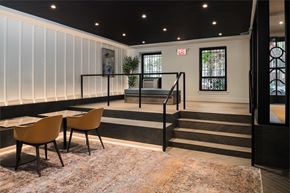 Chicago apartment for rent - the lobby of a building with tables and chairs and a staircase