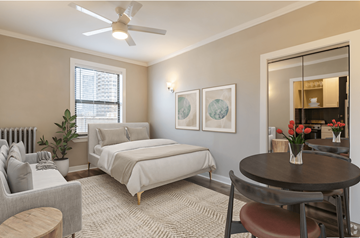 Chicago apartment for rent - a bedroom with a bed and a living room with a couch and a table