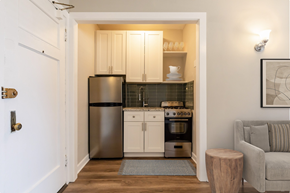 Chicago apartment for rent - a small kitchen with stainless steel appliances and white cabinets
