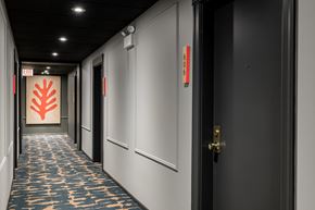 Chicago apartment for rent - A hallway with a carpeted floor and doors on both sides.