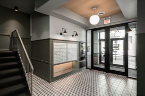 Chicago apartment for rent - a lobby with a staircase and a door to a building with mailboxes