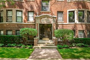 Chicago apartment for rent - A red brick building with a green lawn in front.