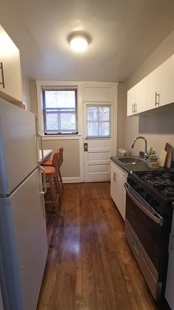 Chicago apartment for rent - A kitchen with a refrigerator, stove, and sink.