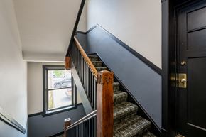 Chicago apartment for rent - a stairway with carpeted stairs next to a window