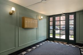 Chicago apartment for rent - the entrance to a room with a door and a cabinet on the wall