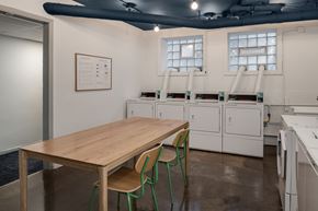 Chicago apartment for rent - A kitchen with a table and chairs in the foreground and a calendar on the wall.