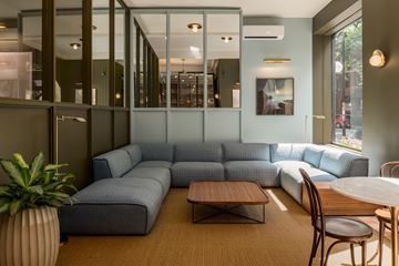 Chicago apartment for rent - A living room with a grey couch and a wooden table.