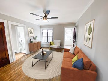 Chicago apartment for rent - A living room with a brown couch and a black coffee table.