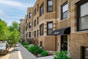 Chicago apartment for rent - a row of brick apartment buildings on a sidewalk
