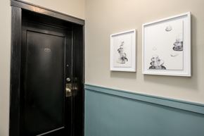 Chicago apartment for rent - two paintings hanging on a wall next to a black door