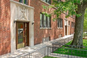 Chicago apartment for rent - a brick building with a tree in front of it