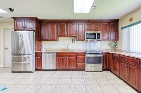 Port Charlotte apartment for rent - community kitchen with stainless steel appliances, tile floors, and ample cabinetry
