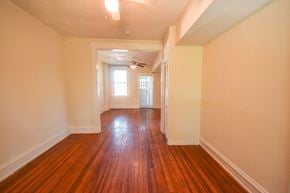 Richmond apartment for rent - an empty living room with wood floors and white walls