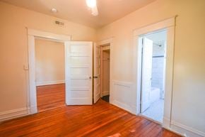 Richmond apartment for rent - an empty living room with wood floors and white doors
