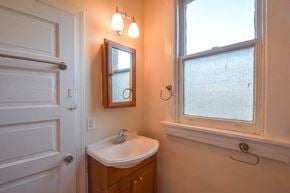 Richmond apartment for rent - a bathroom with a sink and a window and a door