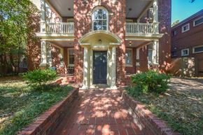 Richmond apartment for rent - the front entrance of a brick house with a black door
