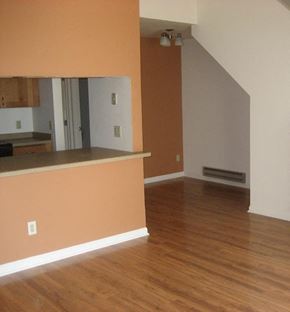 Madison apartment for rent - an empty living room and kitchen with a wood floor