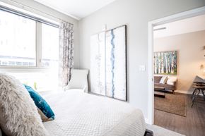 Richmond apartment for rent - a bedroom with a large bed and two windows