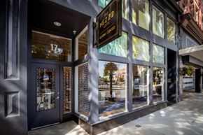 Richmond apartment for rent - the facade of a building with glass windows and a sign for the living cafe