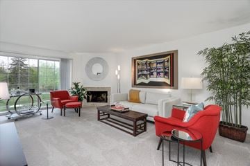 West Bloomfield apartment for rent - A living room with a red chair and a white couch.