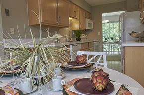 West Bloomfield apartment for rent - a kitchen and dining room with a table with plates on it
