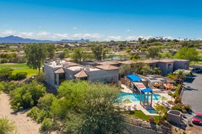 Tucson apartment for rent - an aerial view of a house with a pool and trees