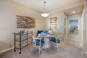 Tucson apartment for rent - a dining area with a table and chairs and a wall art