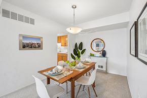 Farmington apartment for rent - A dining room with a wooden table set for two.