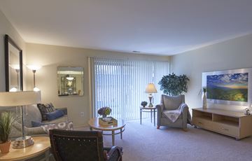 Farmington apartment for rent - a living room with a couch and chairs and a table